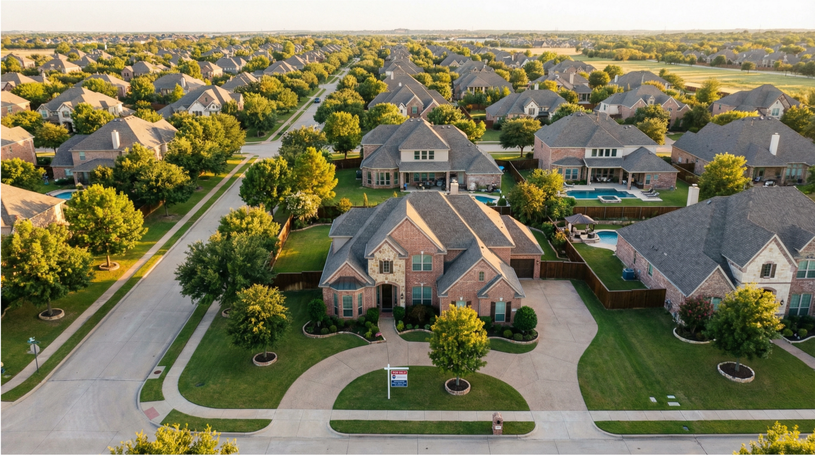 Aerial view of a Frisco, TX neighborhood with a For Sale sign in front of a brick home at golden hour.